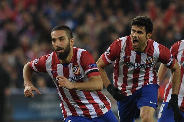 Atletico de Madrid Midfielder, number 10 ARDA - Arda Turan (25), celebrates after scoring a goal (2-1)Atletico de Madrid Forward, number 19 DIEGO COSTA - Diego da Silva Costa (24) during round Round of 16 of the UEFA CHAMPIONS league, soccer match between Atletico de Madrid - AC Milan at the VicentexCalderon estadium, Madrid - Spain by March 11, 2014. 