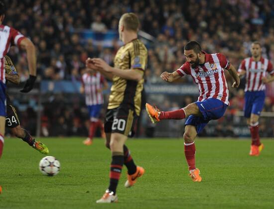 Atletico de Madrid Midfielder, number 10 ARDA - Arda Turan (25), AC Milan Defender, number 20 IGNAZIO ABATE - Ignazio Abate (26) during round Round of 16 of the UEFA CHAMPIONS league, soccer match between Atletico de Madrid - AC Milan at the VicentexCalderon estadium, Madrid - Spain by March 11, 2014. 