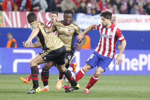 Atletico de MadridÂ s Diego (R) and MilanÂ s Sulley Muntari during 16th Champions League soccer match at Vicente Calderon stadium in Madrid, Spain. March 11, 2014.  (20220967)