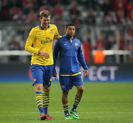 Arsenal s Per Mertesacker looks on dejected at the final whistle with Alex Oxlade-Chamberlain Bayern Munich v Arsenal - Champions League last 16 - Allianz Arena - Munich - Germany - 11 03 2014 - Pic DavidKlein Sportimage EDITORIAL USE ONLY. No use with unauthorised audio, video, data, fixture lists, club league logos or live services. Online in-match use limited to 120 images, no video emulation. No use in betting, games or single club league player publications.