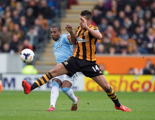 Hull s Jake Livermore puts in a challenge on Fernandinho of Manchester City - Barclays Premier League - Hull vs. Manchester City - KC Stadium - Hull - England - 15th March 2014 - Picture Philip Oldham Sportimage EDITORIAL USE ONLY. No use with unauthorised audio, video, data, fixture lists, club league logos or live services. Online in-match use limited to 120 images, no video emulation. No use in betting, games or single club league player publications.