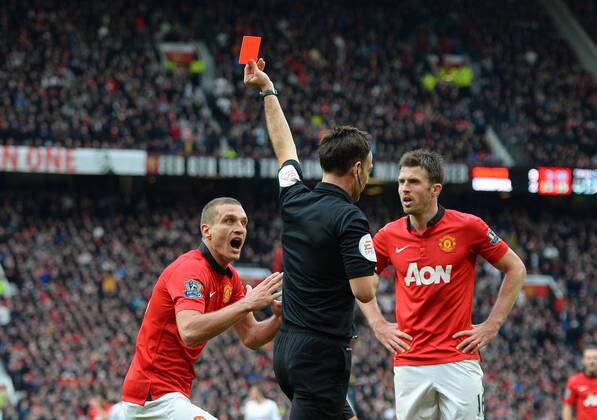 Nemanja Vidic of Manchester United red card by referee Mark Clattenburg - Barclays Premier League - Manchester Utd vs Liverpool - Old Trafford Stadium - Manchester - England - 16th March 2014 - Pic Simon Bellis Sportimage EDITORIAL USE ONLY. No use with unauthorised audio, video, data, fixture lists, club league logos or live services. Online in-match use limited to 120 images, no video emulation. No use in betting, games or single club league player publications.