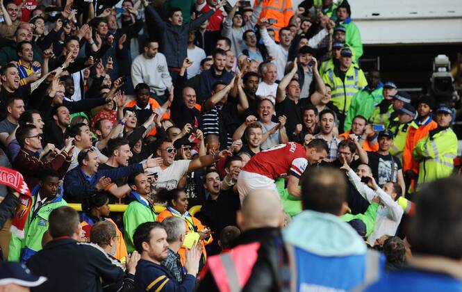 Football - 2013 2014 Premier League Arsenal s Lukas Podolski celebrates with the fans at the final whistle at White Hart Lane. COLORSPORT ANDREW COWIE 