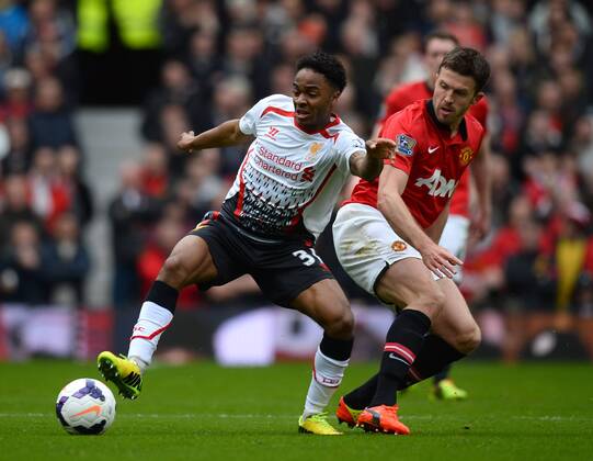 Raheem Sterling of Liverpool tussles with Michael Carrick of Manchester United - Barclays Premier League - Manchester Utd vs Liverpool - Old Trafford Stadium - Manchester - England - 16th March 2014 - Pic Simon Bellis Sportimage EDITORIAL USE ONLY. No use with unauthorised audio, video, data, fixture lists, club league logos or live services. Online in-match use limited to 120 images, no video emulation. No use in betting, games or single club league player publications.