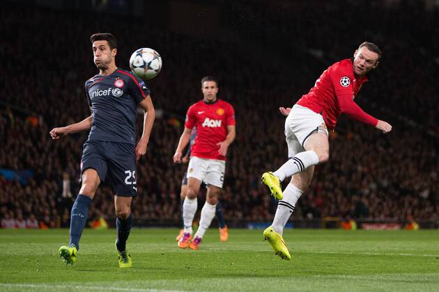 Wayne Rooney of Manchester United sends a header onto the post - UEFA Champions League Round of 16 - Manchester United vs. Olympiacos - Old Trafford - Manchester - England - 19th March 2014 - Picture Philip Oldham Sportimage EDITORIAL USE ONLY. No use with unauthorised audio, video, data, fixture lists, club league logos or live services. Online in-match use limited to 120 images, no video emulation. No use in betting, games or single club league player publications.