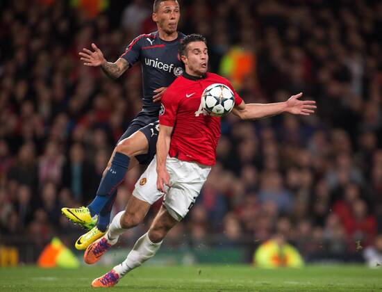 Jose Holebas of Olympiacos brings down Robin van Persie of Manchester United to give way a penalty - UEFA Champions League Round of 16 - Manchester United vs. Olympiacos - Old Trafford - Manchester - England - 19th March 2014 - Picture Philip Oldham Sportimage EDITORIAL USE ONLY. No use with unauthorised audio, video, data, fixture lists, club league logos or live services. Online in-match use limited to 120 images, no video emulation. No use in betting, games or single club league player publications.