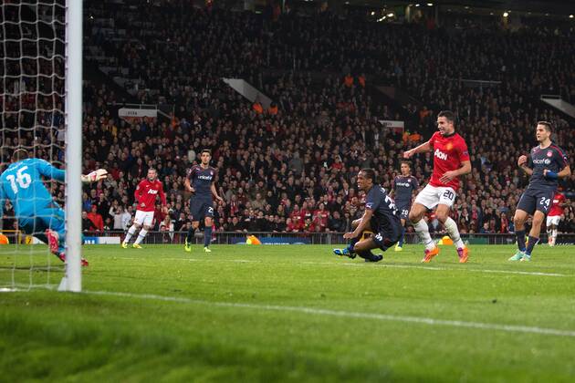 Robin van Persie of Manchester United scores his sides second goal - UEFA Champions League Round of 16 - Manchester United vs. Olympiacos - Old Trafford - Manchester - England - 19th March 2014 - Picture Philip Oldham Sportimage EDITORIAL USE ONLY. No use with unauthorised audio, video, data, fixture lists, club league logos or live services. Online in-match use limited to 120 images, no video emulation. No use in betting, games or single club league player publications.