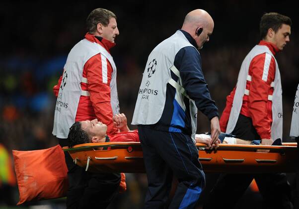 Football - 2013 2014 Champions League - Round of Sixteen, Second Leg: Manchester United vs. Olympiakos Robin van Persie of Manchester United is stretchered from the pitch with a leg injury towards the end of the game at Old Trafford, Manchester 
