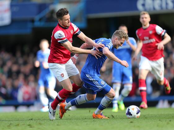 Chelsea s Andre Schurrle tussles with Arsenal s Carl Jenkinson Chelsea vs Arsenal - Premier League - Stamford Bridge - London - England - 22 03 2014 - Pic David Klein Sportimage EDITORIAL USE ONLY. No use with unauthorised audio, video, data, fixture lists, club league logos or live services. Online in-match use limited to 120 images, no video emulation. No use in betting, games or single club league player publications.