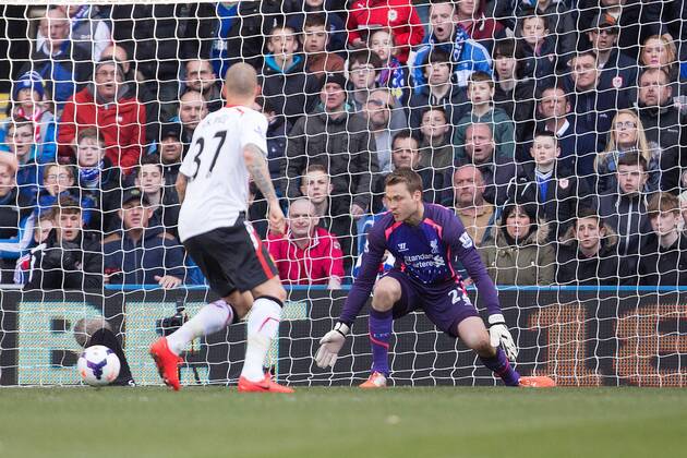 Simon Mignolet of Liverpool looks on helplessly as Cardiff s Jordan Mutch sails past him into the far corner for the opening goal - Barclays Premier League - Cardiff City vs. FC Liverpool - Cardiff City Stadium - Cardiff - Wales - 22nd March 2014 - EDITORIAL USE ONLY. No use with unauthorised audio, video, data, fixture lists, club league logos or live services. Online in-match use limited to 120 images, no video emulation. No use in betting, games or single club league player publications.