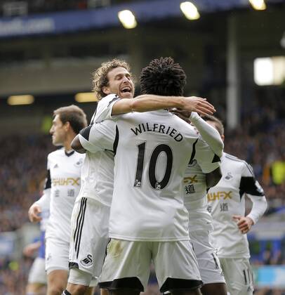 Jose Alberto Canas (left) celebrates with goalscorer Wilfried Bony following the first goal for Swansea - Barclays Premier League - Everton FC vs Swansea City - Goodison Park Stadium - Liverpool - England - 22 03 2014 - EDITORIAL USE ONLY. No use with unauthorised audio, video, data, fixture lists, club league logos or live services. Online in-match use limited to 120 images, no video emulation. No use in betting, games or single club league player publications.