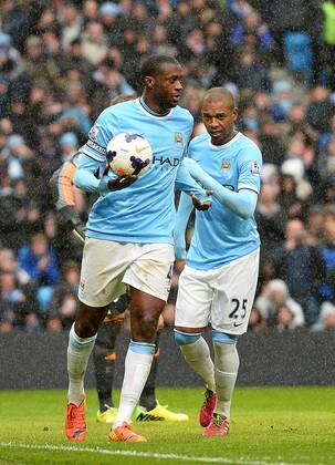 Yaya Toure of Manchester City celebrates scoring his second goal - Barclays Premier League - Manchester City vs FC Fulham - Etihad Stadium - Manchester - England - 22nd March 2014 - EDITORIAL USE ONLY. No use with unauthorised audio, video, data, fixture lists, club league logos or live services. Online in-match use limited to 120 images, no video emulation. No use in betting, games or single club league player publications.