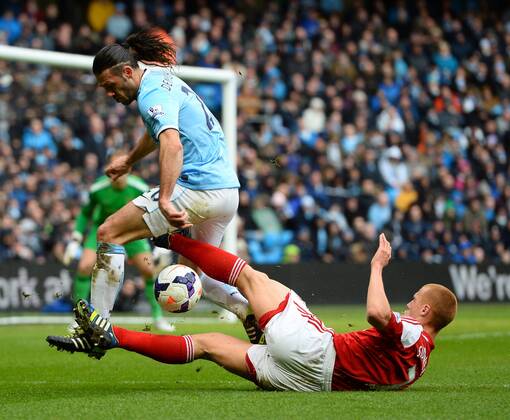Martin Demichelis of Manchester City clears under pressure from Steve Sidwell of Fulham - Barclays Premier League - Manchester City vs FC Fulham - Etihad Stadium - Manchester - England - 22nd March 2014 - EDITORIAL USE ONLY. No use with unauthorised audio, video, data, fixture lists, club league logos or live services. Online in-match use limited to 120 images, no video emulation. No use in betting, games or single club league player publications.