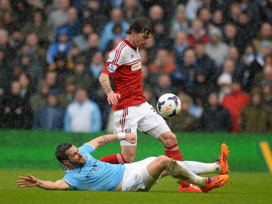 Alvaro Negredo of Manchester City challenges Fernando Amorebieta of Fulham - Barclays Premier League - Manchester City vs FC Fulham - Etihad Stadium - Manchester - England - 22nd March 2014 - EDITORIAL USE ONLY. No use with unauthorised audio, video, data, fixture lists, club league logos or live services. Online in-match use limited to 120 images, no video emulation. No use in betting, games or single club league player publications.