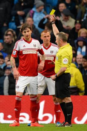 Fernando Amorebieta of Fulham receives the first of his two yellow cards - Barclays Premier League - Manchester City vs FC Fulham - Etihad Stadium - Manchester - England - 22nd March 2014 - EDITORIAL USE ONLY. No use with unauthorised audio, video, data, fixture lists, club league logos or live services. Online in-match use limited to 120 images, no video emulation. No use in betting, games or single club league player publications.