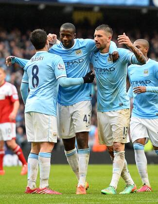 Yaya Toure of Manchester City celebrates his third goal - Barclays Premier League - Manchester City vs FC Fulham - Etihad Stadium - Manchester - England - 22nd March 2014 - EDITORIAL USE ONLY. No use with unauthorised audio, video, data, fixture lists, club league logos or live services. Online in-match use limited to 120 images, no video emulation. No use in betting, games or single club league player publications.