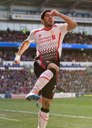 Luis Suarez of Liverpool celebrates scoring his sides fourth goal - Barclays Premier League - Cardiff City vs. FC Liverpool - Cardiff City Stadium - Cardiff - Wales - 22nd March 2014 - EDITORIAL USE ONLY. No use with unauthorised audio, video, data, fixture lists, club league logos or live services. Online in-match use limited to 120 images, no video emulation. No use in betting, games or single club league player publications.