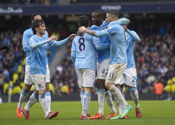 22.03.2014 Manchester, England. Yaya Toure of Manchester City scores to make it 3-0 and celebrates with team matesduring the Premier League game between Manchester City and Fulham from the Etihad Stadium. xMarkxDavisonx  ActionPlus000120181890