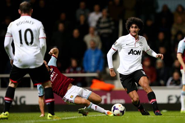 Manchester United s Marouane Fellaini passes across the box to Manchester United s Wayne Rooney - West Ham United v Manchester United (ManU) - Barclays Premier League - Upton Park Stadium - London - 22nd March 2014 - EDITORIAL USE ONLY. No use with unauthorised audio, video, data, fixture lists, club league logos or live services. Online in-match use limited to 120 images, no video emulation. No use in betting, games or single club league player publications.