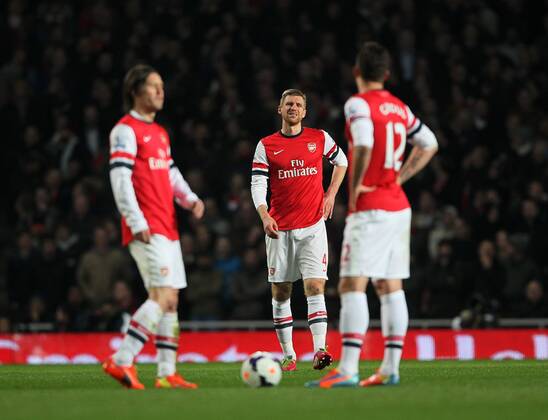 Arsenal s Per Mertesacker looks on dejected after going 1-0 down Arsenal vs Swansea City - Premier League - Emirates Stadium- London - England - 25 03 2014 - Pic David Klein Sportimage EDITORIAL USE ONLY. No use with unauthorised audio, video, data, fixture lists, club league logos or live services. Online in-match use limited to 120 images, no video emulation. No use in betting, games or single club league player publications.