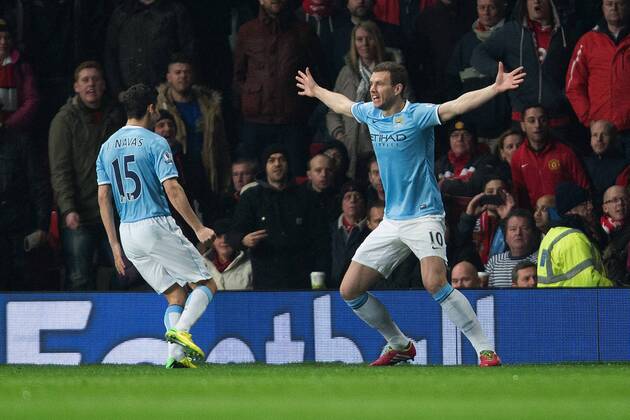 Edin Dzeko of Manchester City celebrates his opening goal - Barclays Premier League - Manchester United vs. Manchester City - Old Trafford - Manchester - England - 25th March 2014 - Picture Philip Oldham Sportimage EDITORIAL USE ONLY. No use with unauthorised audio, video, data, fixture lists, club league logos or live services. Online in-match use limited to 120 images, no video emulation. No use in betting, games or single club league player publications.