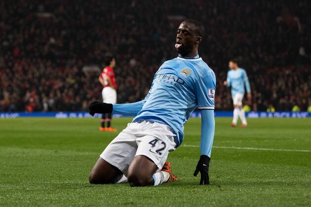 Yaya Toure of Manchester City celebrates scoring his sides third goal - Barclays Premier League - Manchester United vs. Manchester City - Old Trafford - Manchester - England - 25th March 2014 - Picture PhilipOldham Sportimage EDITORIAL USE ONLY. No use with unauthorised audio, video, data, fixture lists, club league logos or live services. Online in-match use limited to 120 images, no video emulation. No use in betting, games or single club league player publications.
