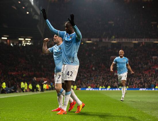 Yaya Toure of Manchester City celebrates scoring his sides third goal - Barclays Premier League - Manchester United vs. Manchester City - Old Trafford - Manchester - England - 25th March 2014 - Picture PhilipOldham Sportimage EDITORIAL USE ONLY. No use with unauthorised audio, video, data, fixture lists, club league logos or live services. Online in-match use limited to 120 images, no video emulation. No use in betting, games or single club league player publications.