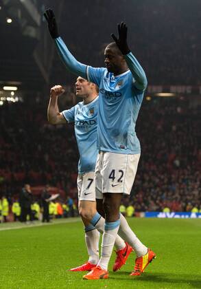 Yaya Toure of Manchester City celebrates scoring his sides third goal - Barclays Premier League - Manchester United vs. Manchester City - Old Trafford - Manchester - England - 25th March 2014 - Picture PhilipOldham Sportimage EDITORIAL USE ONLY. No use with unauthorised audio, video, data, fixture lists, club league logos or live services. Online in-match use limited to 120 images, no video emulation. No use in betting, games or single club league player publications.