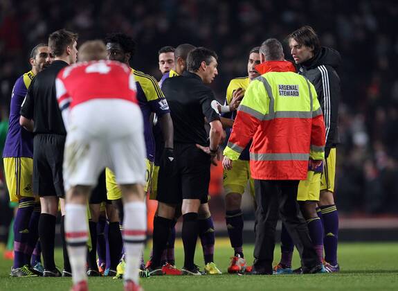 Swansea s players surround referee Lee Probert at the end of the match Arsenal vs Swansea City - Premier League - Emirates Stadium- London - England - 25 03 2014 - Pic David Klein Sportimage EDITORIAL USE ONLY. No use with unauthorised audio, video, data, fixture lists, club league logos or live services. Online in-match use limited to 120 images, no video emulation. No use in betting, games or single club league player publications.