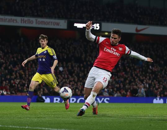 Arsenal s Olivier Giroud scoring his sides second goal Arsenal vs Swansea City - Premier League - Emirates Stadium- London - England - 25 03 2014 - Pic David Klein Sportimage EDITORIAL USE ONLY. No use with unauthorised audio, video, data, fixture lists, club league logos or live services. Online in-match use limited to 120 images, no video emulation. No use in betting, games or single club league player publications.