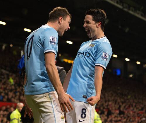 Edin Dzeko of Manchester City celebrates his second goal with Samir Nasri - Barclays Premier League - Manchester United vs. Manchester City - Old Trafford - Manchester - England - 25th March 2014 - Picture Philip Oldham Sportimage EDITORIAL USE ONLY. No use with unauthorised audio, video, data, fixture lists, club league logos or live services. Online in-match use limited to 120 images, no video emulation. No use in betting, games or single club league player publications.