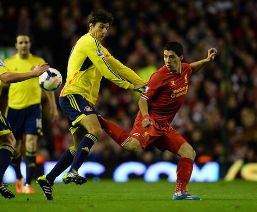Luis Suarez of Liverpool challenged by Santiago Vergini of Sunderland - Barclays Premier League - Liverpool vs Sunderland - Anfield Stadium - Liverpool - England - 26th March 2014 - Pic Simon Bellis Sportimage EDITORIAL USE ONLY. No use with unauthorised audio, video, data, fixture lists, club league logos or live services. Online in-match use limited to 120 images, no video emulation. No use in betting, games or single club league player publications.