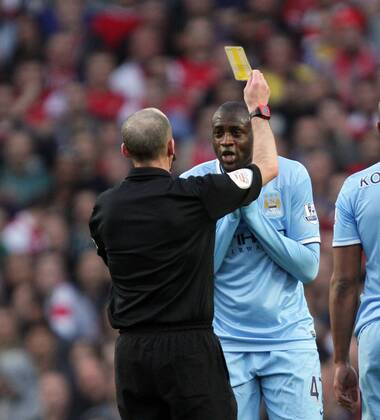 Arsenal v Manchester City . . London, UK . . 29.03.14 Yaya Toure (MC) gets a yellow card from referee Michael Dean. 