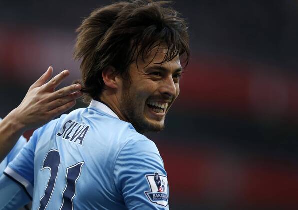 David Silva of Manchester City celebrates scoring during the Barclays Premier League match between Arsenal and Manchester City at Emirates Stadium in London, Britain on March 29, 2014. The match ended with a 1-1 draw. (Xinhua Wang Lili) (SP) LONDON-SOCCER-PREMIER LEAGUE-- ARSENAL FC London VS MANCHESTER CITY