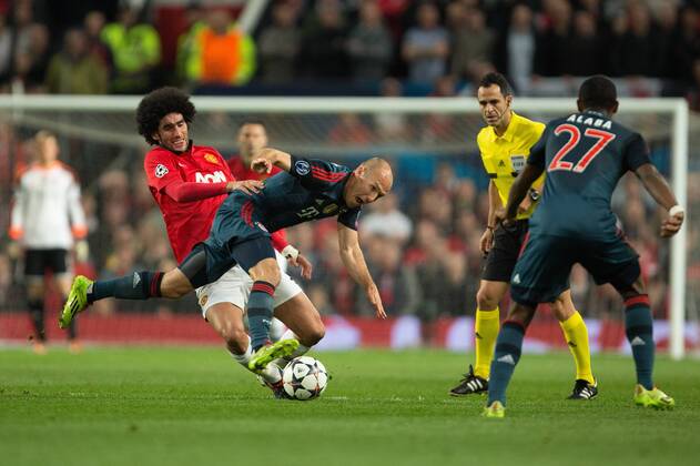 Marouane Fellaini of Manchester United (ManU) challenges Arjen Robben of Munich - UEFA Champions League - Manchester United (ManU) vs. Bayern Munich FC - Old Trafford - Manchester - - 1st April 2014 - Picture PhilipxOldham Sportimage EDITORIAL USE ONLY. No use with unauthorised audio, video, data, fixture lists, club league logos or live services. Online in-match use limited to 120 images, no video emulation. No use in betting, games or single club league player publications.