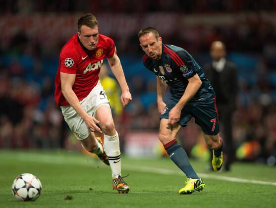 Phil Jones of Manchester United (ManU) and Frank Ribery of Munich in action - UEFA Champions League - Manchester United (ManU) vs. Bayern Munich FC - Old Trafford - Manchester - - 1st April 2014 - Picture PhilipxOldham Sportimage EDITORIAL USE ONLY. No use with unauthorised audio, video, data, fixture lists, club league logos or live services. Online in-match use limited to 120 images, no video emulation. No use in betting, games or single club league player publications.