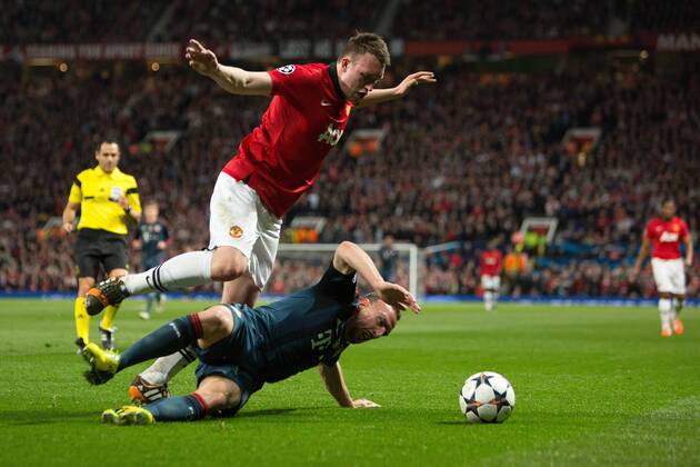 Phil Jones of Manchester United (ManU) and Frank Ribery of Munich in action - UEFA Champions League - Manchester United (ManU) vs. Bayern Munich FC - Old Trafford - Manchester - - 1st April 2014 - Picture PhilipxOldham Sportimage EDITORIAL USE ONLY. No use with unauthorised audio, video, data, fixture lists, club league logos or live services. Online in-match use limited to 120 images, no video emulation. No use in betting, games or single club league player publications.