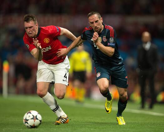 Phil Jones of Manchester United (ManU) and Frank Ribery of Munich in action - UEFA Champions League - Manchester United (ManU) vs. Bayern Munich FC - Old Trafford - Manchester - - 1st April 2014 - Picture PhilipxOldham Sportimage EDITORIAL USE ONLY. No use with unauthorised audio, video, data, fixture lists, club league logos or live services. Online in-match use limited to 120 images, no video emulation. No use in betting, games or single club league player publications.