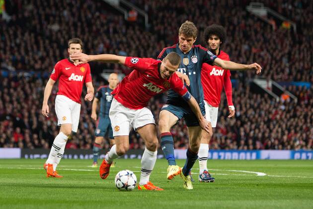 Nemanja Vidic of Manchester United (ManU) struggles with Thomas Müller of Munich - UEFA Champions League - Manchester United (ManU) vs. Bayern Munich FC - Old Trafford - Manchester - - 1st April 2014 - Picture PhilipxOldham Sportimage EDITORIAL USE ONLY. No use with unauthorised audio, video, data, fixture lists, club league logos or live services. Online in-match use limited to 120 images, no video emulation. No use in betting, games or single club league player publications.