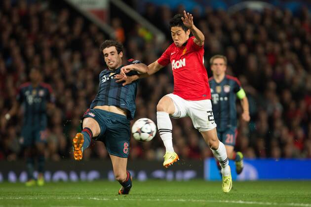 Javi Martinez of Munich challenges Shinji Kagawa of Manchester United (ManU) - UEFA Champions League - Manchester United (ManU) vs. Bayern Munich FC - Old Trafford - Manchester - - 1st April 2014 - Picture PhilipxOldham Sportimage EDITORIAL USE ONLY. No use with unauthorised audio, video, data, fixture lists, club league logos or live services. Online in-match use limited to 120 images, no video emulation. No use in betting, games or single club league player publications.