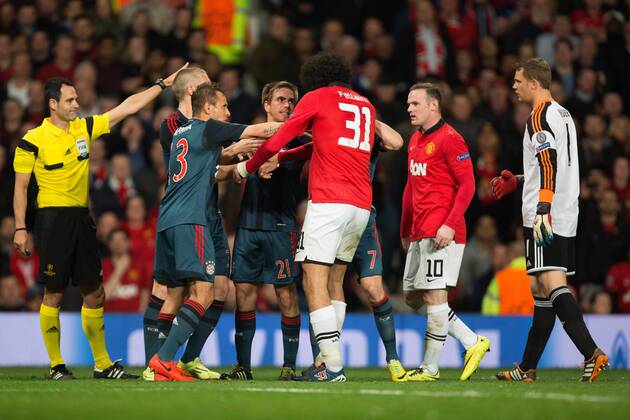 Philipp Lahm of Munich and Marouane Fellaini of Manchester United (ManU) exchange words - UEFA Champions League - Manchester United (ManU) vs. Bayern Munich FC - Old Trafford - Manchester - - 1st April 2014 - Picture PhilipxOldham Sportimage EDITORIAL USE ONLY. No use with unauthorised audio, video, data, fixture lists, club league logos or live services. Online in-match use limited to 120 images, no video emulation. No use in betting, games or single club league player publications.