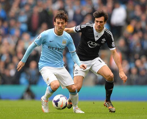 David Silva of Manchester City tussles with Jack Cork of Southampton - Barclays Premier League - Manchester City v Southampton - Etihad Stadium - Manchester - England - 5th April 2014 - Pic Simon Bellis Sportimage EDITORIAL USE ONLY. No use with unauthorised audio, video, data, fixture lists, club league logos or live services. Online in-match use limited to 120 images, no video emulation. No use in betting, games or single club league player publications.