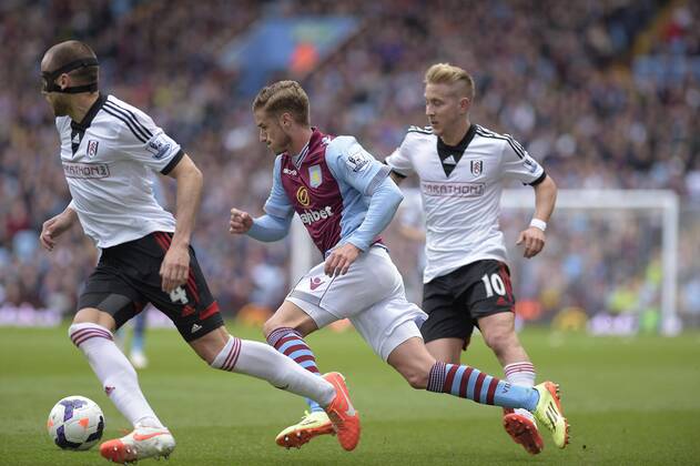 Joe Bennett of Aston Villa goes past John Heitinga (left) and Lewis Holtby of Fulham - Football - Barclays Premier League - Aston Villa vs Fulham - Villa Park Birmingham - Season 13 14 - 05 04 2014 Pic Malcolm Couzens Sportimage EDITORIAL USE ONLY. No use with unauthorised audio, video, data, fixture lists, club league logos or live services. Online in-match use limited to 120 images, no video emulation. No use in betting, games or single club league player publications.