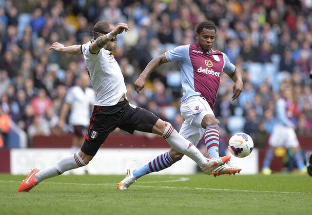 John Heitinga of Fulham (left) competes with Leandro Bacuna of Aston Villa - Football - Barclays Premier League - Aston Villa vs Fulham - Villa Park Birmingham - Season 13 14 - 05 04 2014 Pic Malcolm Couzens Sportimage EDITORIAL USE ONLY. No use with unauthorised audio, video, data, fixture lists, club league logos or live services. Online in-match use limited to 120 images, no video emulation. No use in betting, games or single club league player publications.