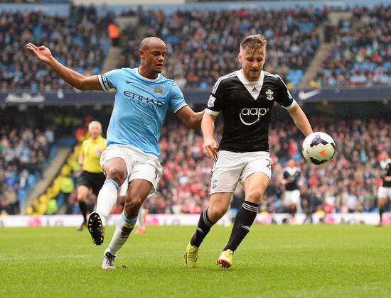 Vincent Kompany of Manchester City and Luke Shaw of Southampton - Barclays Premier League - Manchester City v Southampton - Etihad Stadium - Manchester - England - 5th April 2014 - Pic Simon Bellis Sportimage EDITORIAL USE ONLY. No use with unauthorised audio, video, data, fixture lists, club league logos or live services. Online in-match use limited to 120 images, no video emulation. No use in betting, games or single club league player publications.