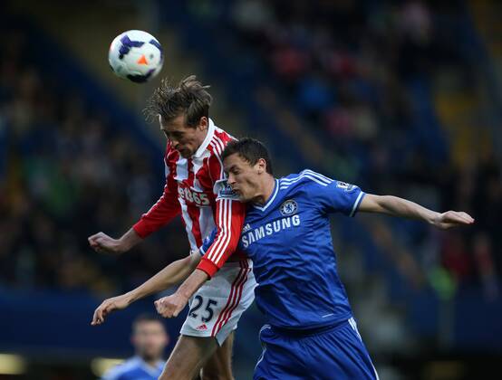 Chelsea s Nemanja Matic tussles with Stoke s Peter Crouch Chelsea vs Stoke City- Premier League - Stamford Bridge- London - England - 05 03 2014 - Pic David Klein Sportimage EDITORIAL USE ONLY. No use with unauthorised audio, video, data, fixture lists, club league logos or live services. Online in-match use limited to 120 images, no video emulation. No use in betting, games or single club league player publications.