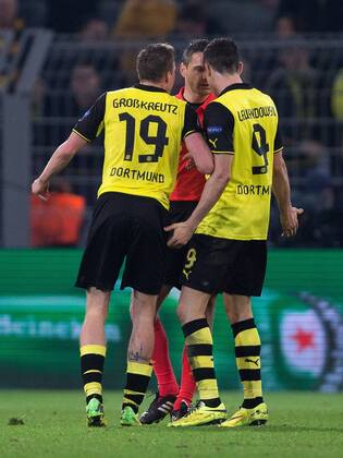 Kevin Grosskreutz and Robert Lewandowski of Dortmund confront the referee at full time - UEFA Champions League - Quarter Final 2nd Leg - Borussia Dortmund vs. Real Madrid - Signal Iduna Park - Dortmund - Germany - 8th April 2014 - Picture Philip Oldham Sportimage EDITORIAL USE ONLY. No use with unauthorised audio, video, data, fixture lists, club league logos or live services. Online in-match use limited to 120 images, no video emulation. No use in betting, games or single club league player publications.
