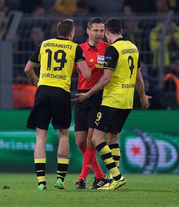 Kevin Grosskreutz and Robert Lewandowski of Dortmund confront the referee at full time - UEFA Champions League - Quarter Final 2nd Leg - Borussia Dortmund vs. Real Madrid - Signal Iduna Park - Dortmund - Germany - 8th April 2014 - Picture Philip Oldham Sportimage EDITORIAL USE ONLY. No use with unauthorised audio, video, data, fixture lists, club league logos or live services. Online in-match use limited to 120 images, no video emulation. No use in betting, games or single club league player publications.