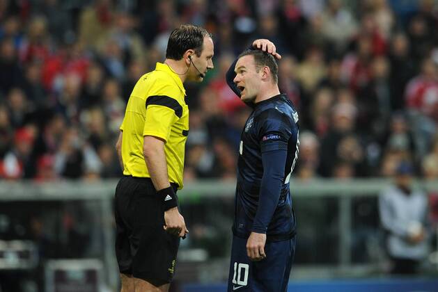 Football - 2013 2014 Champions League - Quarter-Final, Second Leg: Bayern Munich vs. Manchester United Wayne Rooney of Manchester United protests his innocence following a foul on Dante of Bayern Munich at the Allianz Arena, Munich 
