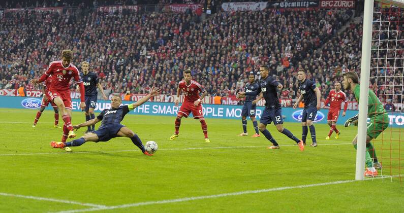 09.04.2014, Fussball Champions League 2013 2014, Viertelfinale, Rückspiel, FC Bayern München - Manchester United, in der Allianz-Arena München. Torschuss zum 2:1 für Bayern von Thomas Müller (li, Bayern München). Nemanja Vidic (2.v.li, Manchester United) ist ohne Abwehrchance. 